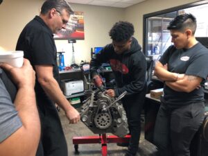 Enginetech Engine Class in Session. Students work on engine.